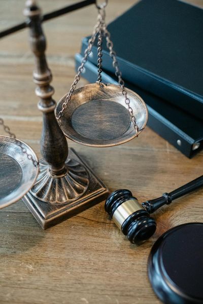 Legal scales of justice and gavel on a wood desk